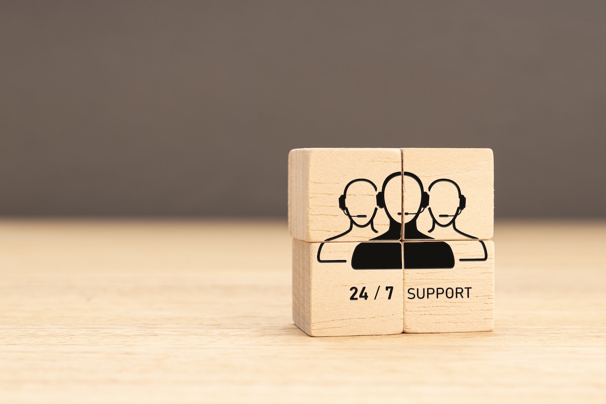 24-7 Customer support concept. Group of wooden block with Group of Call Center Workers icon
